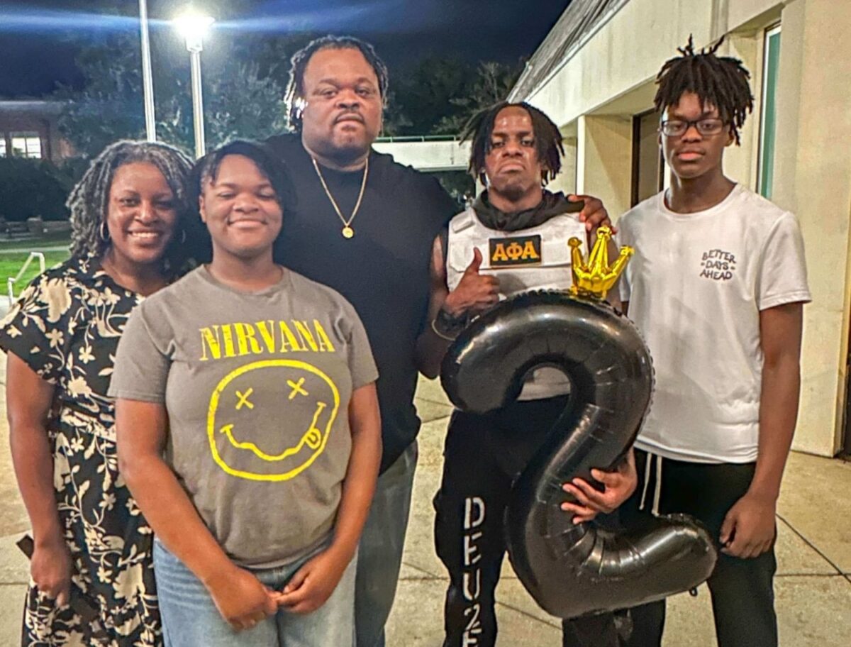 family celebrating a young Alpha Phi Alpha man
