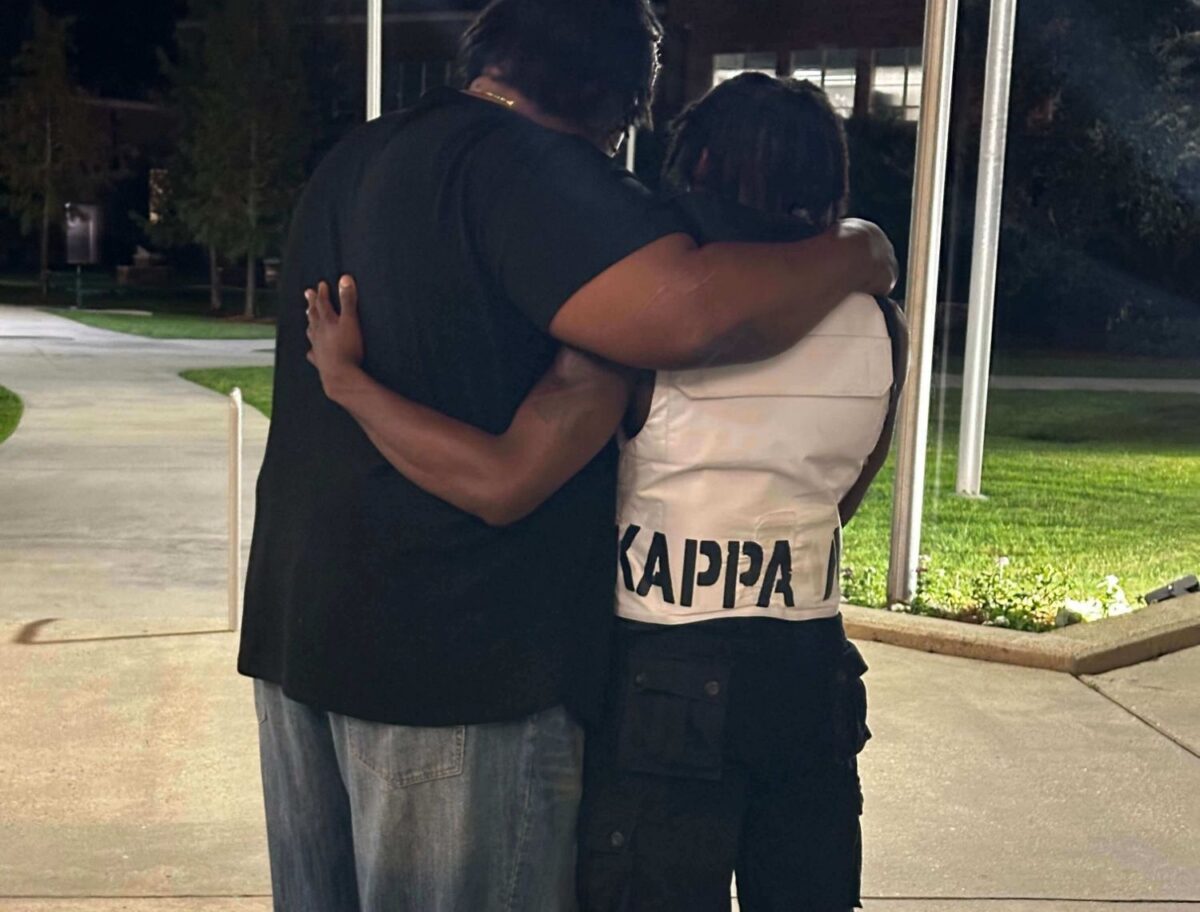 father embracing his Alpha Phi Alpha son